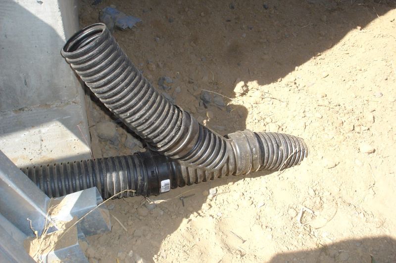 Downspout inlet connected to a buried French drain
